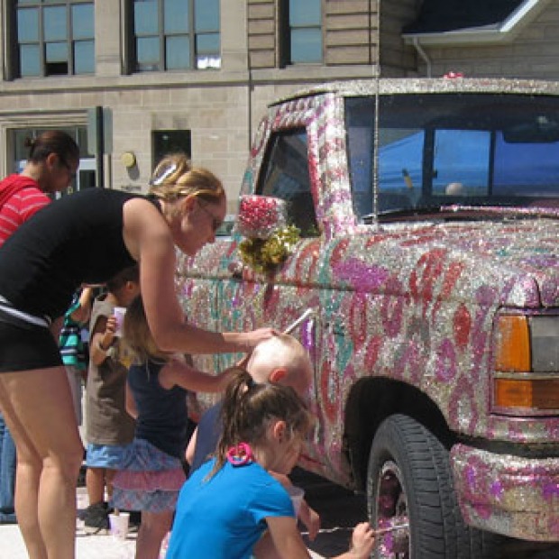 young people decorate a truck with glitter